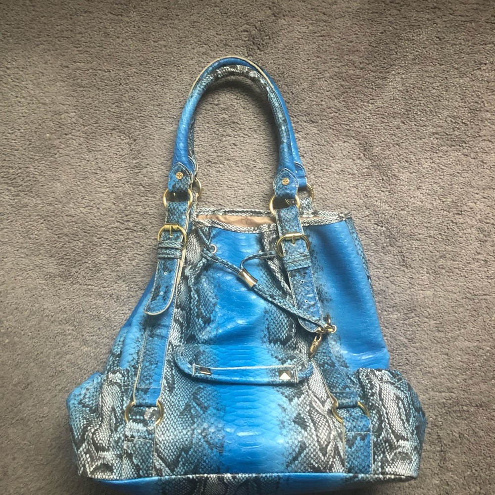 Snakeskin print turquoise tote includes dust bag.